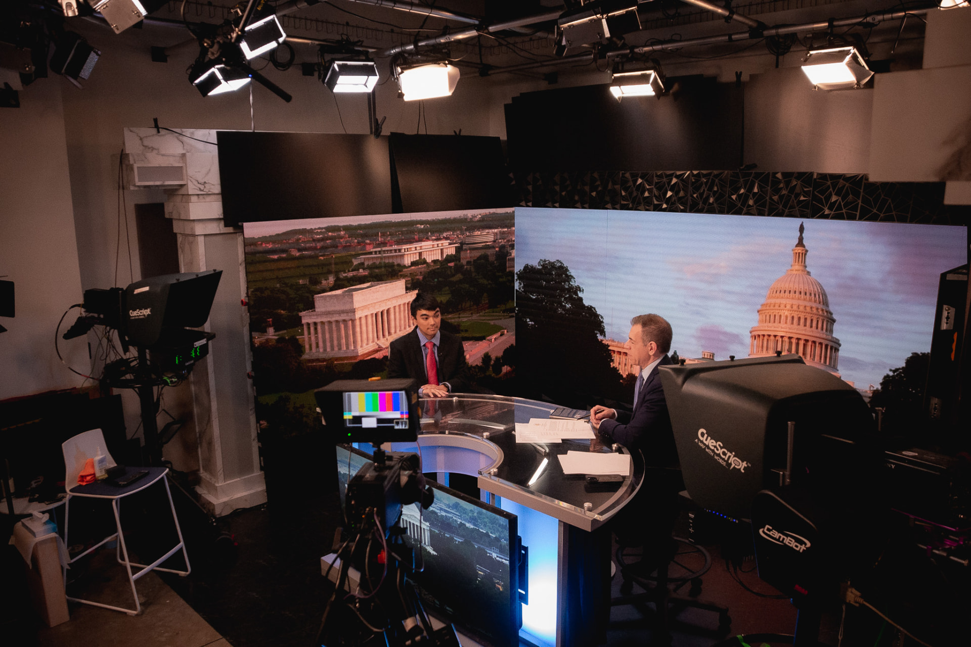 Media training for scientists: co-founder Mark Albert coaches NASA engineer Evan Kawamura on camera in a Washington, D.C. television studio