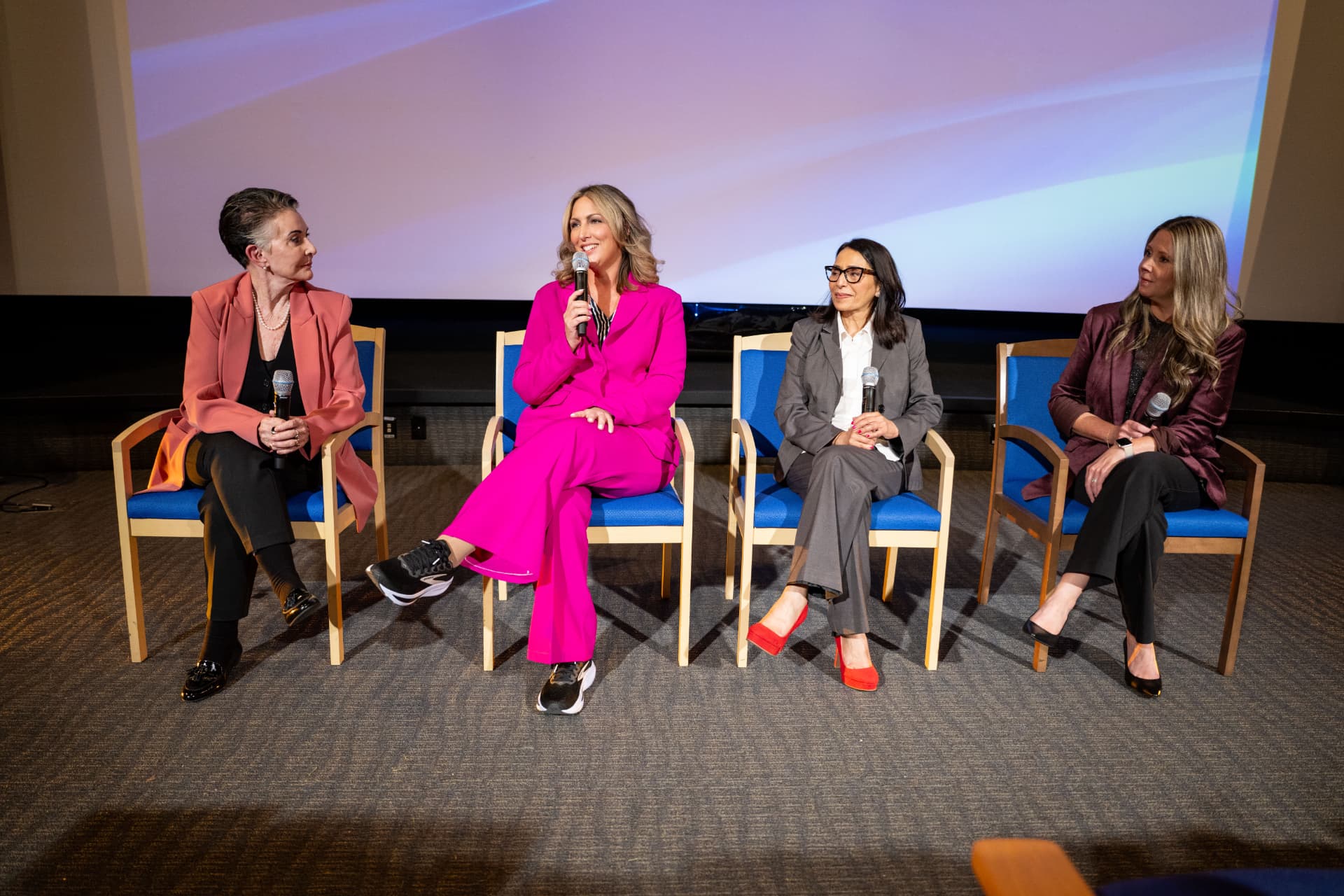 Four women sharing perspectives during a panel discussion