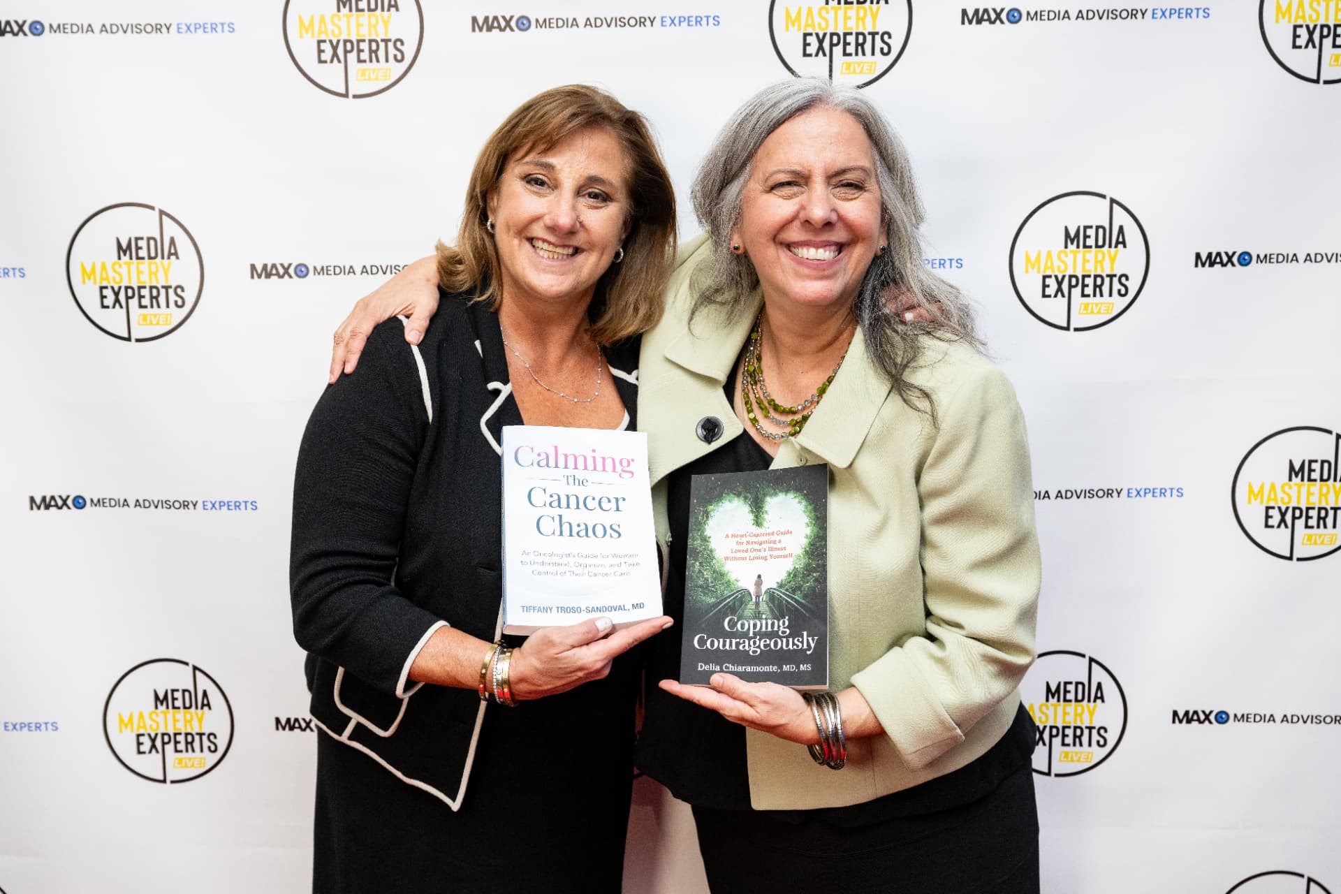 Dr. Tiffany Troso-Sandoval and Dr. Delia Chiaramonte, two physicians who completed MME LIVE! media training, holding up copies of their books